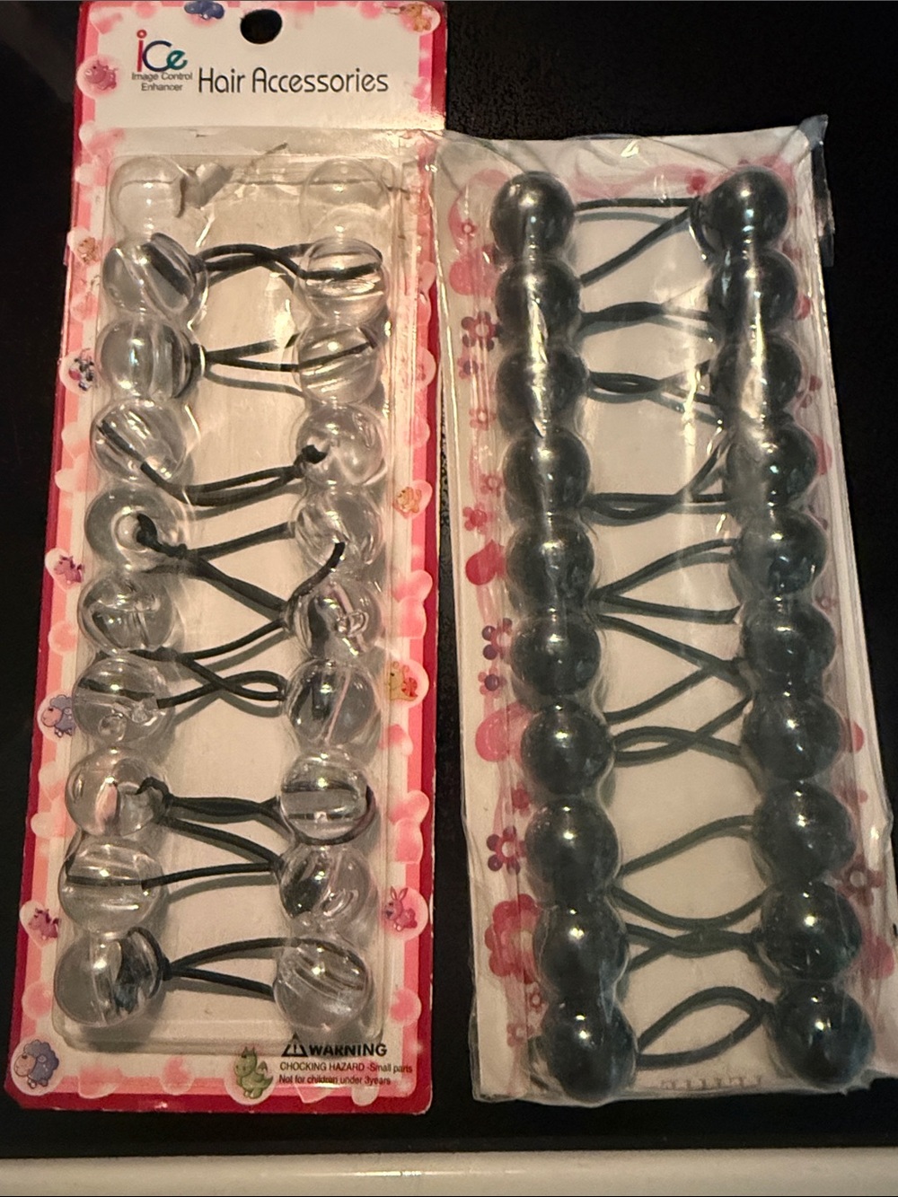 19 hair ties with balls clear and  black colored